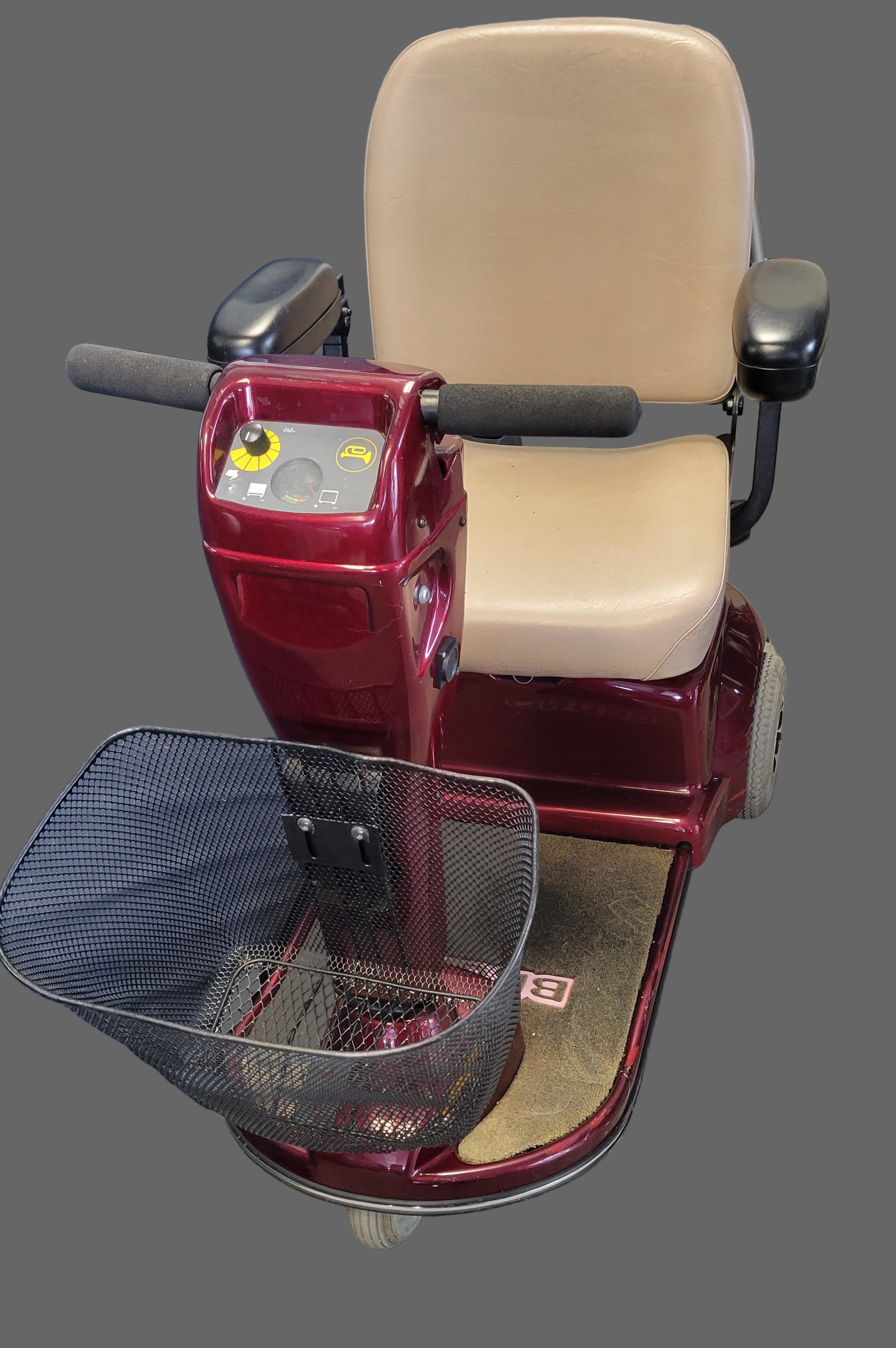 Red mobility scooter with beige seat on a gray background